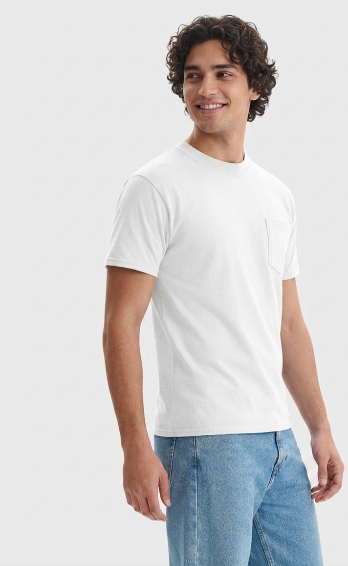 A man wearing a white short-sleeve crewneck t-shirt with a left chest pocket, paired with light blue jeans, photographed against a solid light gray background.