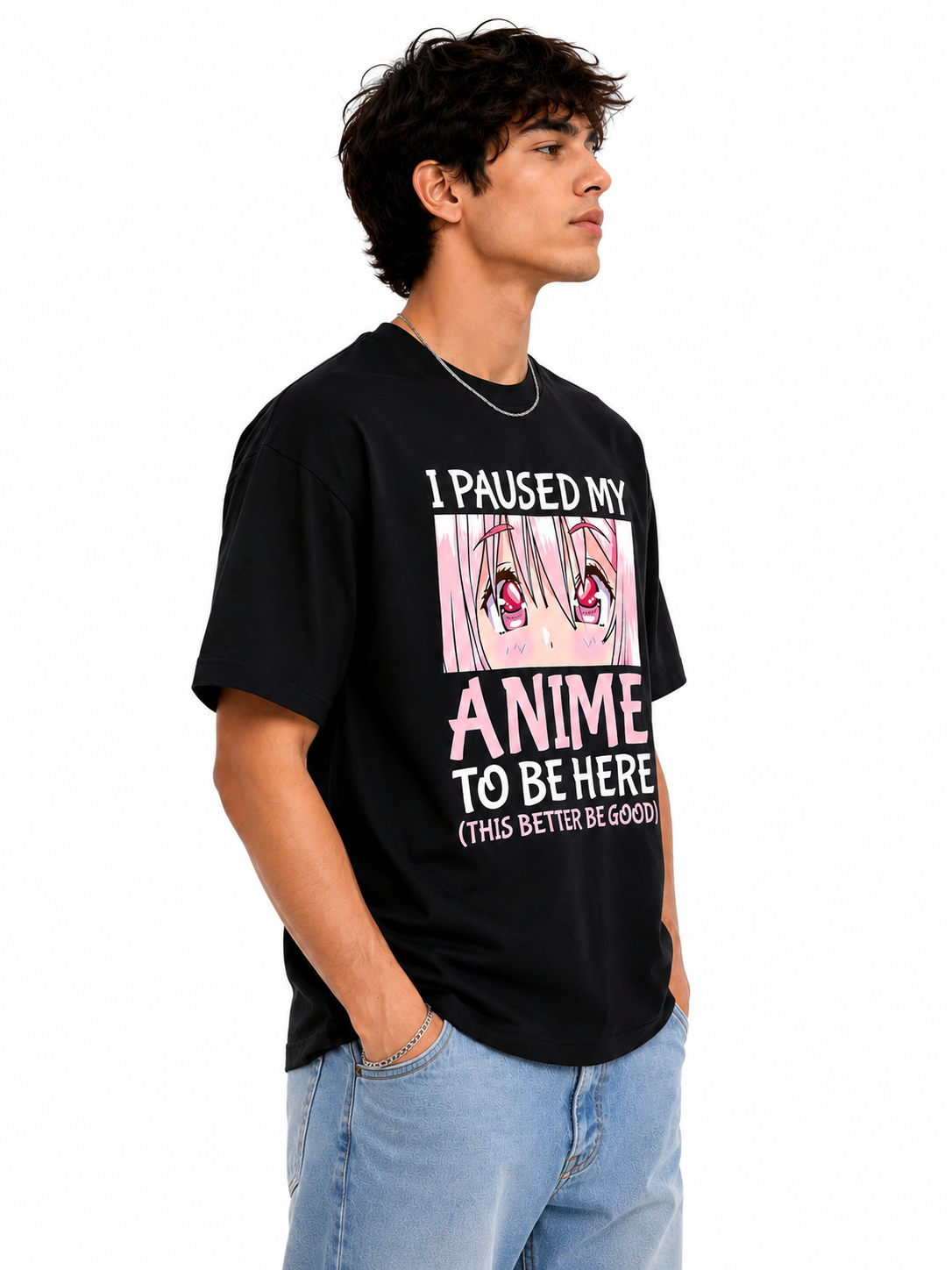A man wearing a black graphic t-shirt with anime text and a pink-haired character print, paired with light blue jeans, photographed against a plain white background.