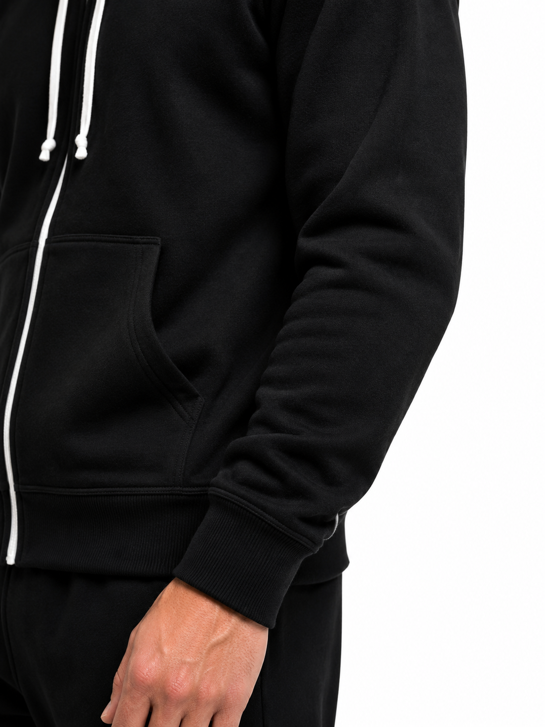 Close-up of a person wearing a black zip-up hoodie with white drawstrings and a white zipper track, shown against a plain white background.